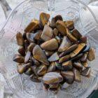 tumbled tigers eye stones in a bowl
